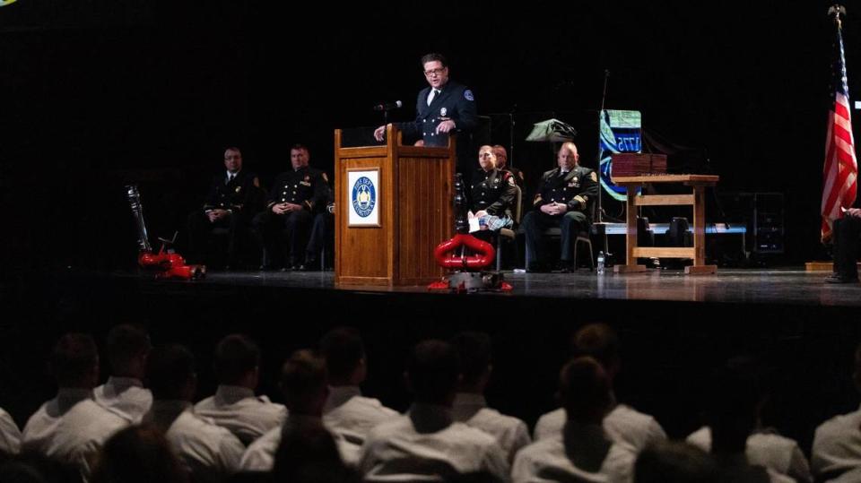 Firefighter Andy Carter of the Lexington Fire Department gives an introduction to the 69th graduating class of 27 new probationary firefighters during the Fire Recruit Graduation at LexCity Church, December 3, 2021.