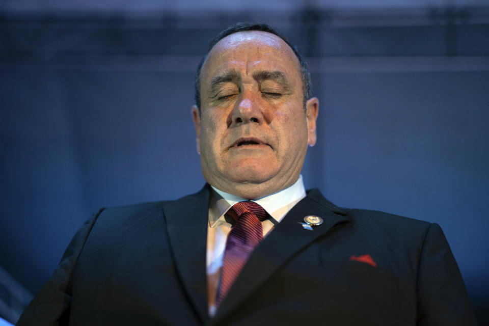 ADDS THAT HE IS PRAYING - Alejandro Giammatei, presidential candidate of the Vamos party, closes his eyes to pray as he stands before supporters after partial election results were announced in Guatemala City, Sunday, Aug. 11, 2019. Giammattei headed for a victory in Sunday’s presidential runoff election, garnering favor with voters for his get-tough approach on crime and socially conservative values. (AP Photo/ Santiago Billy)