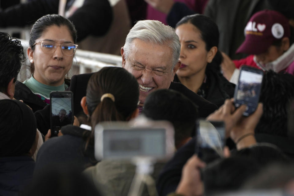 Mexican President Andrés Manuel López Obrador greets supporters as he arrives to a ceremony to inaugurate a "mega-pharmacy" warehouse in Huehuetoca, Mexico, Friday, Dec. 29, 2023. It is the president's solution to help end a supply issue for hospitals that don't have specific medicine needed by patients. (AP Photo/Fernando Llano)