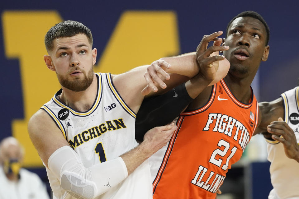 Michigan center Hunter Dickinson (1) and Illinois center Kofi Cockburn (21) battle for position in the first half of an NCAA college basketball game in Ann Arbor, Mich., Tuesday, March 2, 2021. (AP Photo/Paul Sancya)