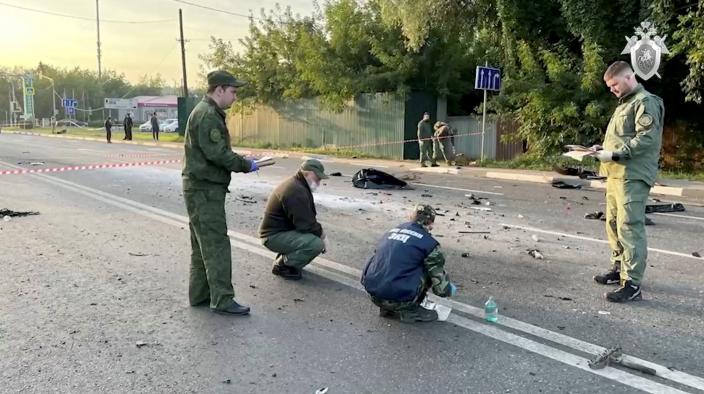 Investigators work at the site of a suspected car bomb attack that killed Darya Dugina, daughter of ultra-nationalist Russian ideologue Alexander Dugin, in the Moscow region, Russia August 21, 2022.