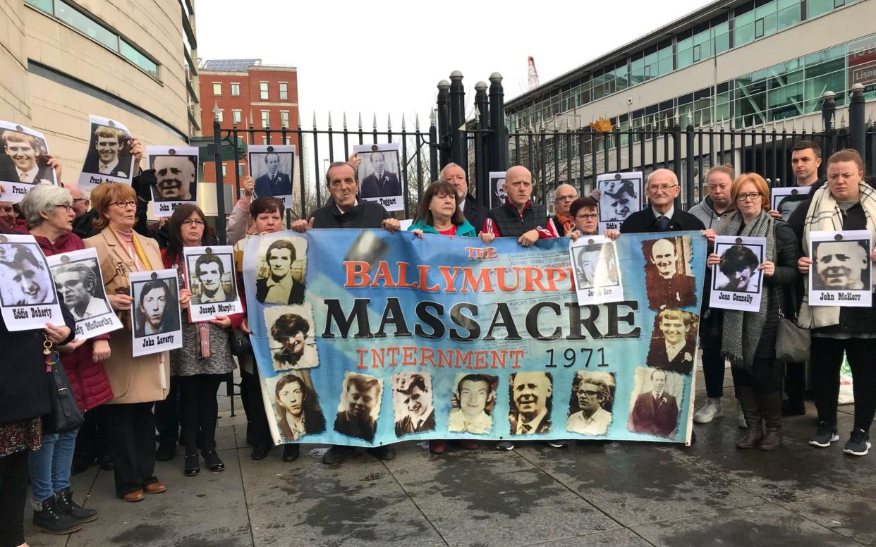 The families of the ten who were killed gather outside Laganside Courts on Monday - PA