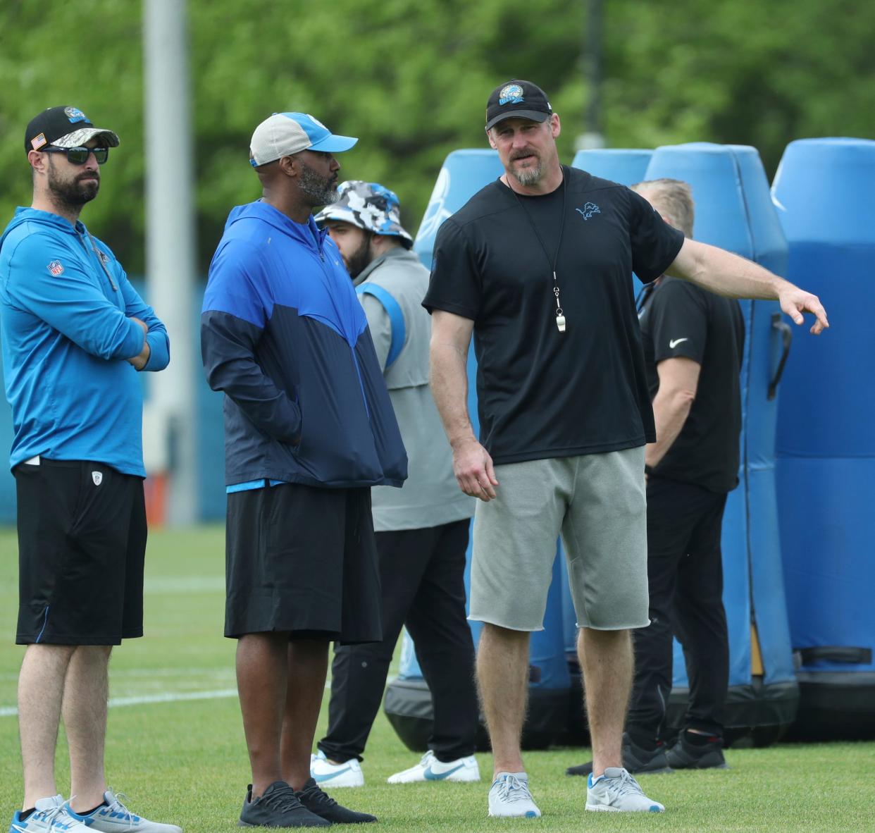 Detroit Lions chief operating officer Mike Disner, general manager Brad Holmes and coach Dan Campbell watch drills during rookie minicamp Saturday, May 13, 2023 in Allen Park.