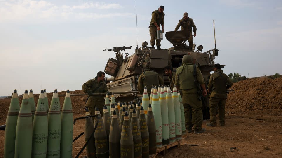 Israeli soldiers take position near the border between Gaza and Israel on October 9. - Oren Ziv/AP