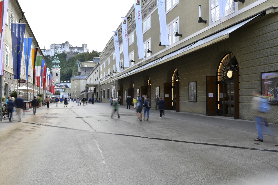 Out side view of the opera house , right, in Salzburg, Austria, Wednesday, Aug. 14, 2019 where singer Placido Domingo will perfom 'Luisa Miller' by Giuseppe Verdi. Numerous women have told The Associated Press that celebrated opera superstar Placido Domingo tried to pressure them into sexual relationships by dangling jobs and sometimes punishing them when they refused his advances. (AP Photo/Kerstin Joensson)