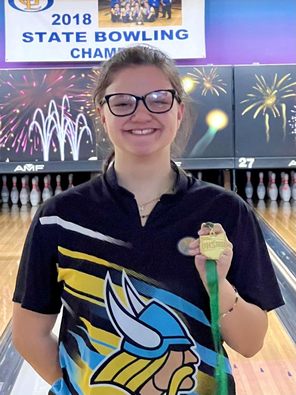 River Valley senior Alexis Manning shows off her Division II girls bowling district championship medal at HP Lanes. She followed it up with a state runner-up medal at the same venue on Saturday.