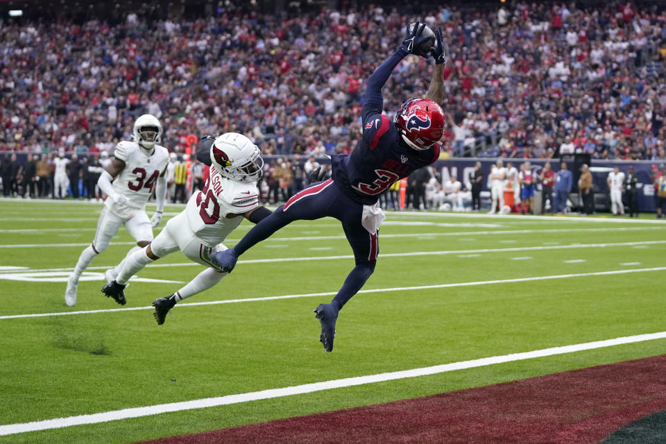 Houston Texans wide receiver Tank Dell (3) catches a touchdown pass as Arizona Cardinals cornerback Marco Wilson (20) defends in the first half of an NFL football game in Houston, Sunday, Nov. 19, 2023. (AP Photo/Eric Christian Smith)