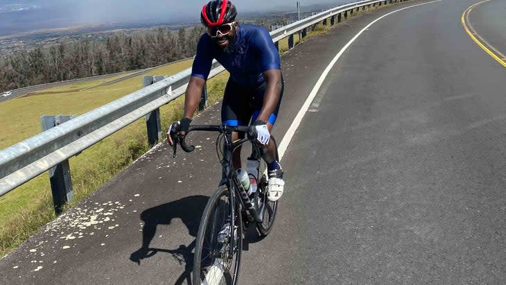 smiling man on road bike