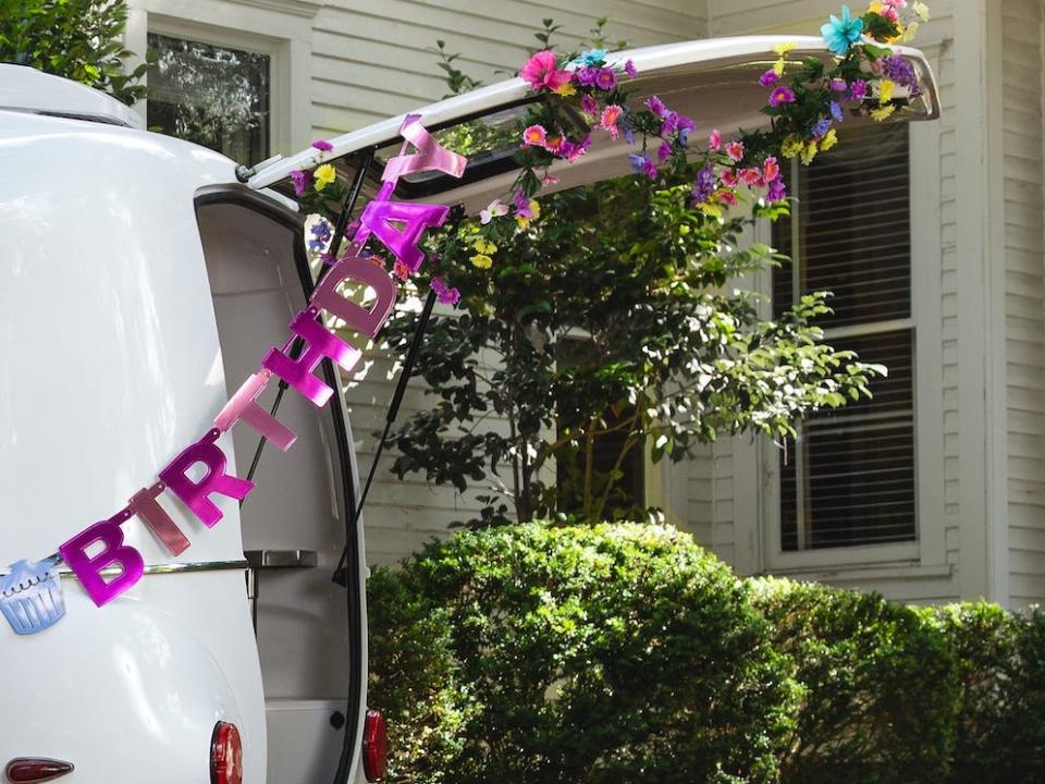 A trailer being used as a recreational area at a birthday party.