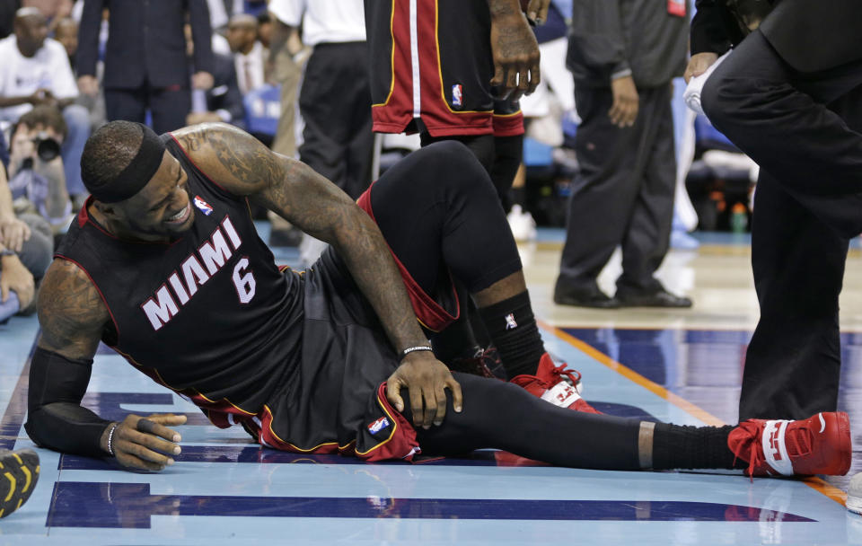 Miami Heat's LeBron James grimaces after being injured during the second half in Game 4 of an opening-round NBA basketball playoff series against the Charlotte Bobcats in Charlotte, N.C., Monday, April 28, 2014. (AP Photo/Chuck Burton)