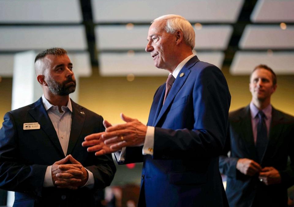 PHOTO: Republican presidential candidate and former Arkansas Gov. Asa Hutchinson, right, speaks with Billy Wilson, of the Iowa Firearms Coalition, at the Iowa Faith & Freedom Coalition's fall banquet, Sept. 16, 2023, in Des Moines, Iowa. (Bryon Houlgrave/AP)