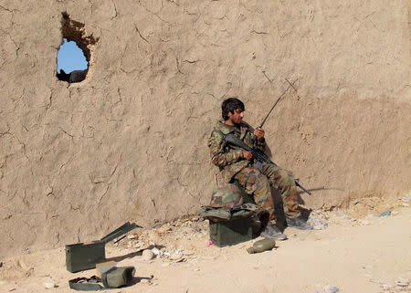 An Afghan National Army (ANA) soldier speaks on a radio at an outpost in Helmand province, Afghanistan in this December 20, 2015 file photo. REUTERS/Abdul Malik/Files