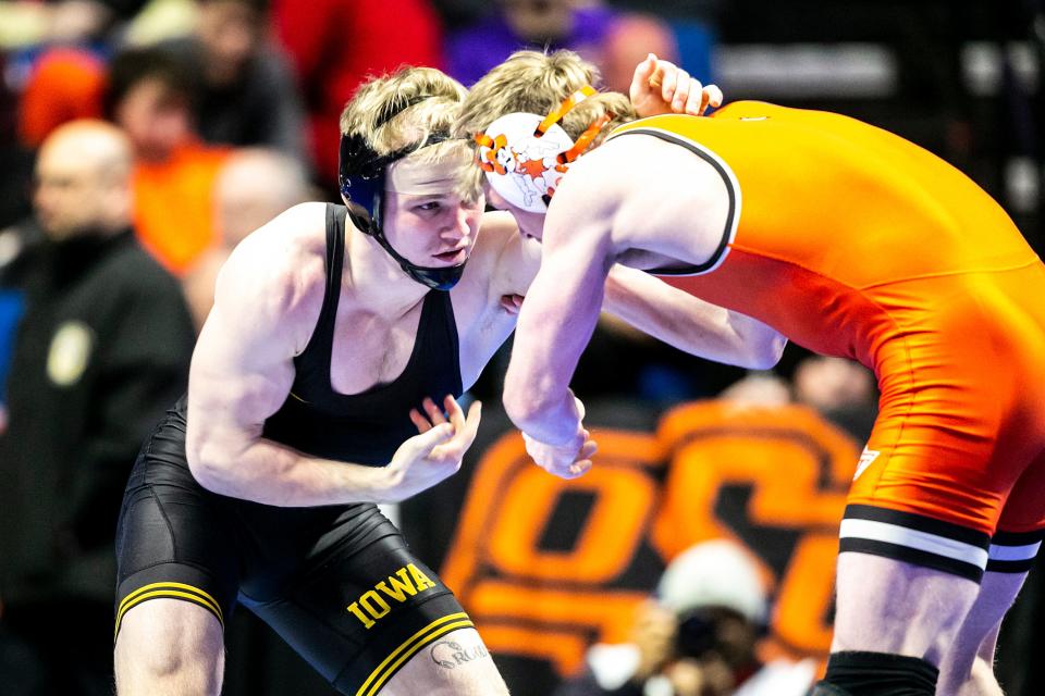 Iowa's Nelson Brands, left, beat Oklahoma State's Dustin Plott for fifth place at 174 pounds on Saturday in Tulsa.