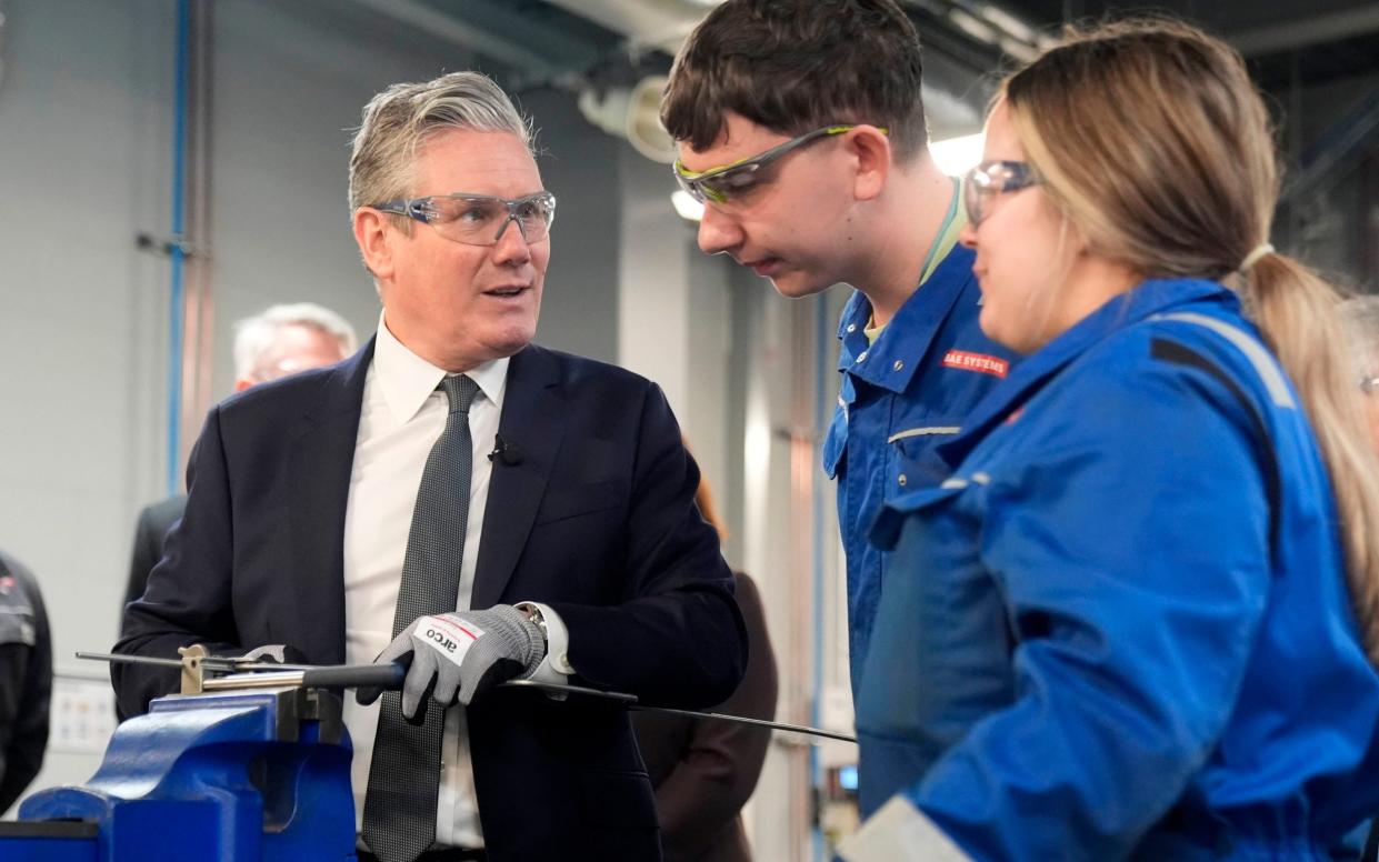 Sir Keir Starmer, the Labour leader, is pictured today talking to workers during a visit to BAE Systems in Barrow-in-Furness