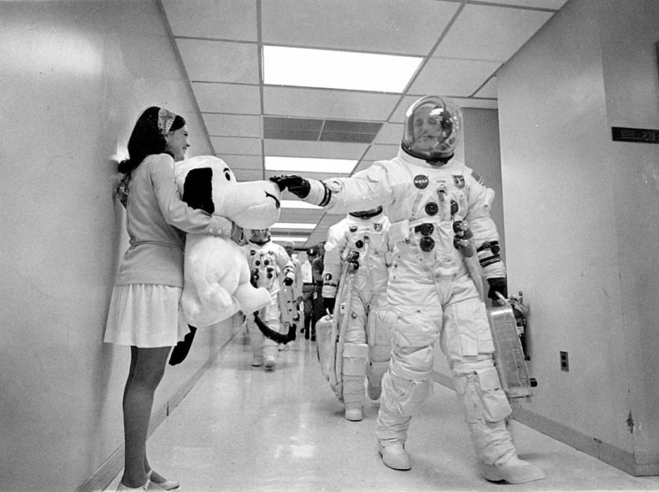 Astronaut Office secretary Jamye Flowers Coplin (holding Snoopy) watches as the Apollo 10 crew of Thomas Stafford, Eugene Cernan and John Young depart for the launch pad in May 1969.