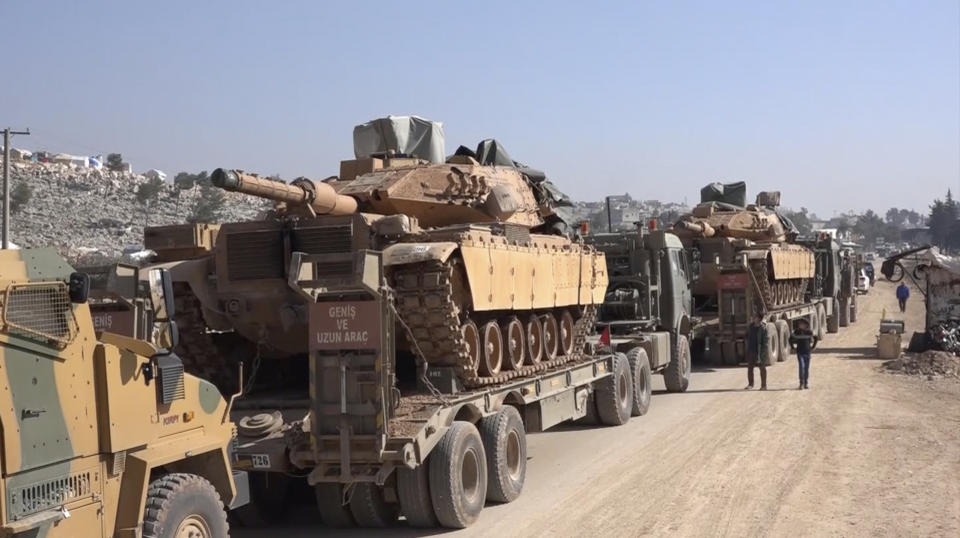 In this frame grab from video taken on Sunday, Feb. 2, 2020, a Turkey Armed Forces convoy is seen at the northern town of Sarmada, in Idlib province, Syria. A large Turkish military convoy moved into the rebel-held areas of northwest Syria on Sunday, witnesses on the ground said, adding it appeared to be heading towards the south of Idlib province. (AP Photo/APTN)