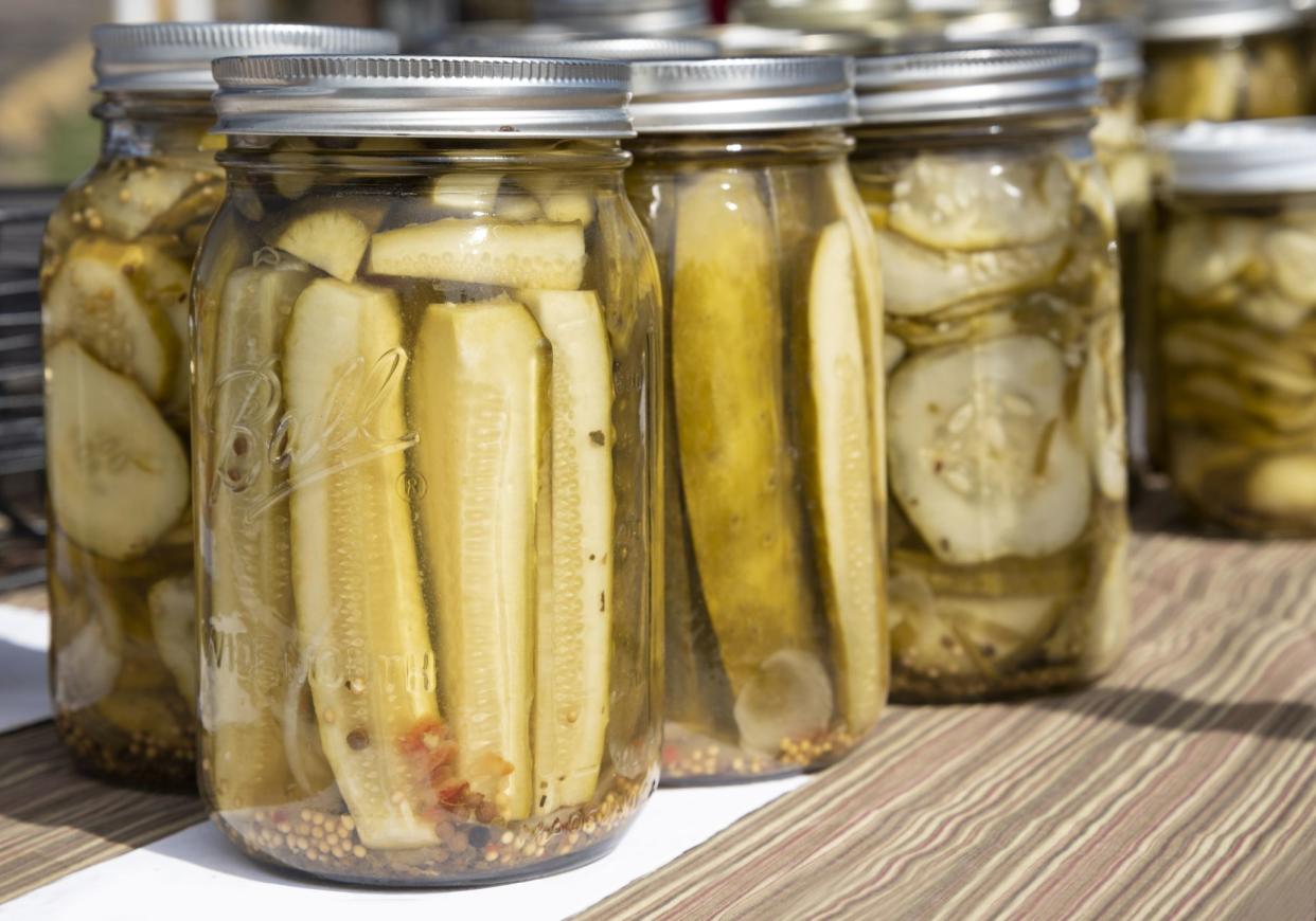 Natural pickles in jars sold at a farmer's market stand