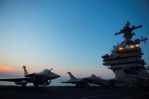 A French Navy Rafale jet is seen early in the morning on the deck of the USS George H.W. Bush aircraft carrier where French crews are honing their skills, in the Atlantic Ocean
