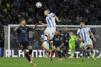 Real Madrid's Joselu, left, and Real Sociedad's Igor Zubeldia challenge for the ball during the Spanish La Liga soccer match between Real Sociedad and Real Madrid in San Sebastian, Spain, Friday, April 26, 2024. (AP Photo/Alvaro Barrientos)