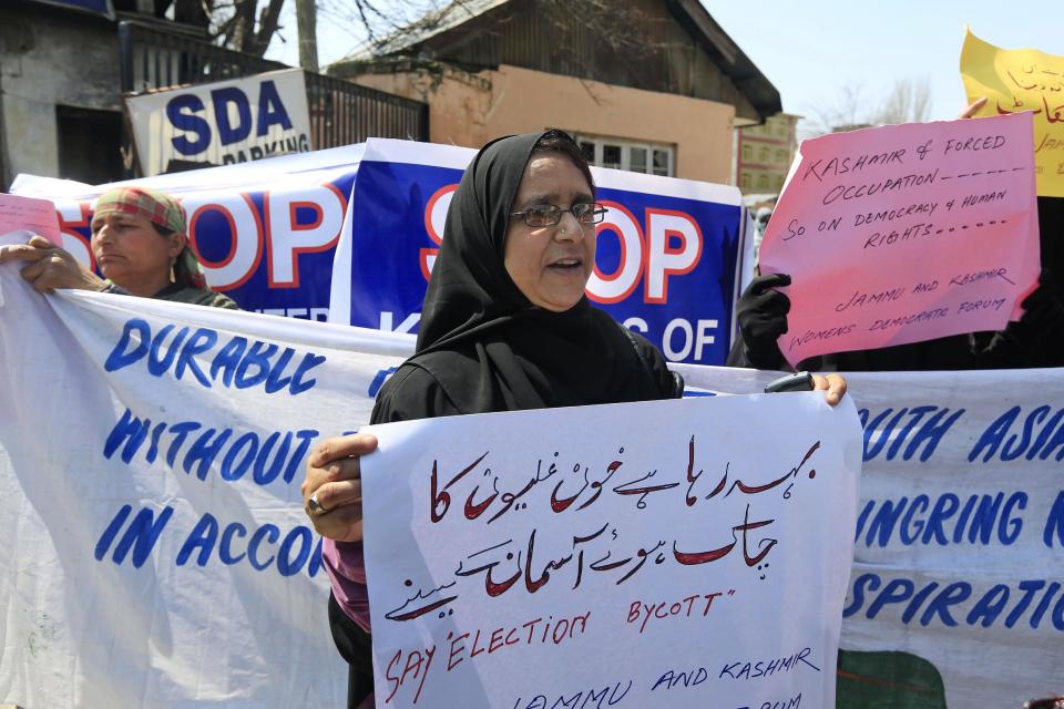 Activists of Jammu Kashmir women's democratic forum hold placards during a protest in Srinagar, India, Thursday, April 10, 2014. Nearly a dozen activists protested Thursday in Indian Kashmir’s main city calling for the boycott of Indian parliamentary elections. India started the world's largest election Monday where the country's 814 million electorate will vote in stages over the next five weeks.(AP Photo/Dar Yasin)