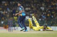 Australia's Alex Carey successfully completes a run as Sri Lanka's Maheesh Theekshana watches during the fifth one-day international cricket match between Australia and Sri Lanka in Colombo, Sri Lanka, Friday, June 24, 2022. (AP Photo/Eranga Jayawardena)