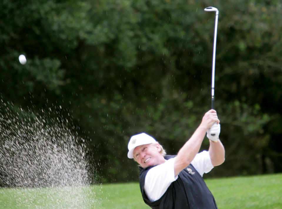 Donald Trump hits out of the sand on the first hole of the Poppy Hills Golf Course during the second round of the AT&T Pebble Beach National Pro-Am in Pebble Beach, Calif., Friday, Feb. 11, 2005. (AP Photo/Jeff Chiu)