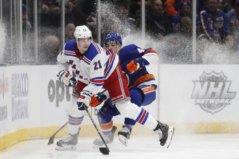 New York Rangers center Brett Howden (21) looks to pass with New York Islanders center Jean-Gabriel Pageau (44) defending during the second period of an NHL hockey game, Tuesday, Feb. 25, 2020, in Uniondale, N.Y. (AP Photo/Kathy Willens)