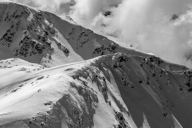 Any type of adventure can be had in the Spearhead. I was getting ready to drop into my line from the top of Blackcomb Mountain, when I noticed these two unknown skiers carving their paths in the snow, a couple ridges over from me.<p>Photo: Guy Fattal</p>