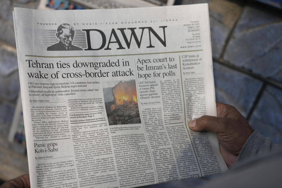 A Pakistani reads the front page of a morning newspaper covering Iran's strike, at a stall in Islamabad, Pakistan, Thursday, Jan. 18, 2024. Pakistan's air force launched retaliatory airstrikes early Thursday on Iran allegedly targeting militant positions, an attack that killed at least seven people and further raised tensions between the neighboring nations. (AP Photo/Anjum Naveed)