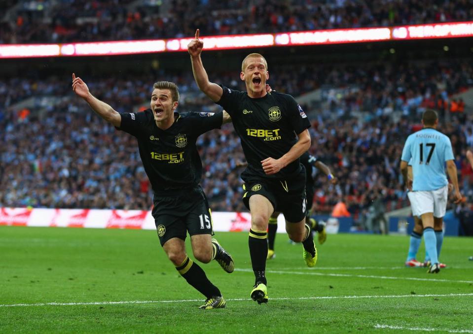 McManaman celebrates with Ben Watson, who scored the winning goal in Wigan’s 1-0 win at Wembley (The FA/Getty)