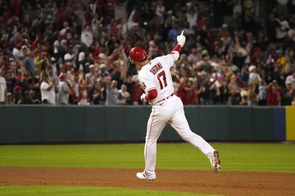 Angels' Shohei Ohtani celebrates as he heads to third after hitting a solo home run.