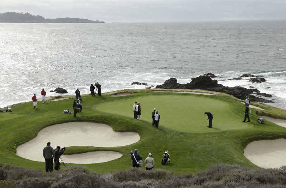 Phil Mickelson putts on the seventh green of the Pebble Beach Golf Links during the second round of the AT&T Pebble Beach Pro-Am golf tournament on Friday, Feb. 7, 2014, in Pebble Beach, Calif. (AP Photo/Eric Risberg)