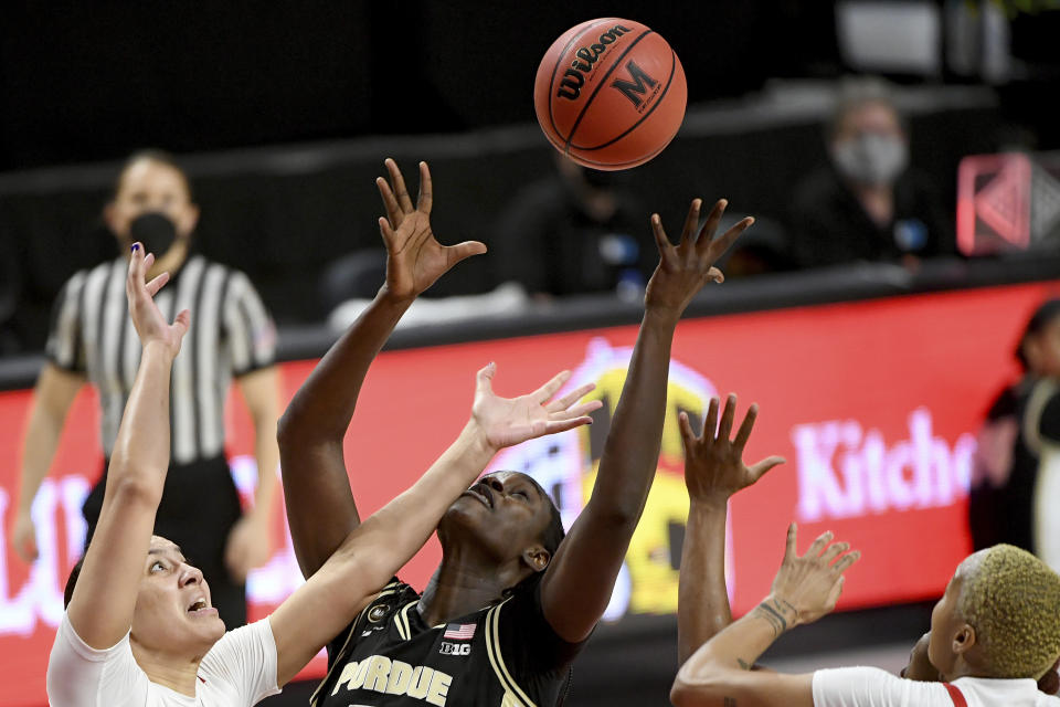 Maryland forward Mimi Collins (2), left, and Purdue center Fatou Diagne (45) battle for a rebound during the second half of an NCAA college basketball game, Sunday, Jan. 10, 2021, in College Park, Md. (AP Photo/Will Newton)