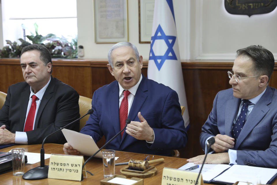 Israeli Prime Minister Benjamin Netanyahu, center, Foreign Minister Israel Katz, left, and the government secretary Tzachi Braverman attend the weekly cabinet meeting at his office in Jerusalem, Israel, Sunday, Sept. 8, 2019. (Abir Sultan/Pool Photo via AP)