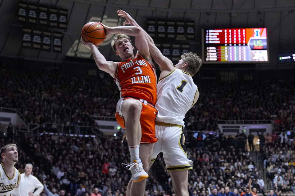 Illinois forward Marcus Domask (3) is fouled as he shoots by Purdue forward Caleb Furst (1) during the first half of an NCAA college basketball game in West Lafayette, Ind., Friday, Jan. 5, 2024. (AP Photo/Michael Conroy)