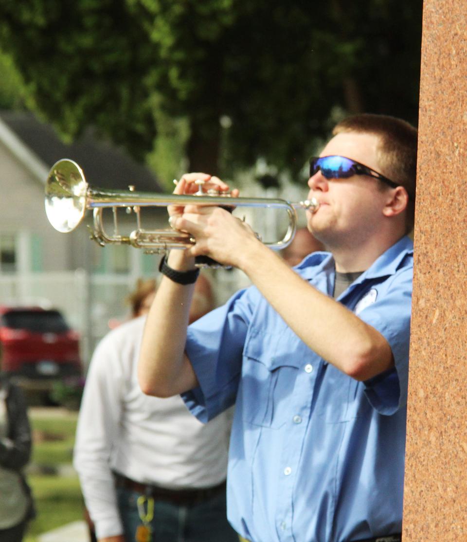 A member of the Pontiac Municipal Band provides the echo for Taps at the Memorial Day Service Monday at Southside Cemetery.