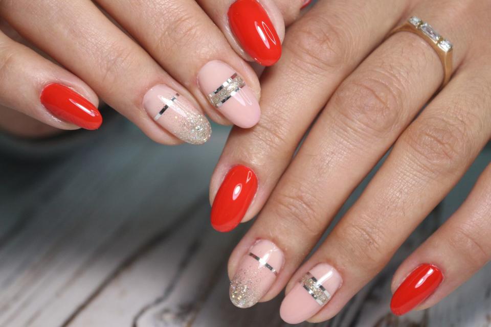 <p>Think of this design as jewelry for your nails! The striking red and pink combination is set off with glittery tips and silver bands that mimic rings. </p>