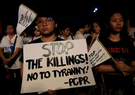 Participants display placards as they participate in a procession against plans to reimpose death penalty and intensify drug war during "Walk for Life" in Luneta park, Metro Manila, Philippines February 24, 2018. REUTERS/Romeo Ranoco