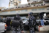 Lebanese policemen stand guard outside the Lebanese Journalists Syndicate, where ex-Nissan chief Carlos Ghosn is scheduled to hold a press conference, in Beirut, Lebanon, Wednesday, Jan. 8, 2020. The disgraced former chairman of Nissan is expected to speak to journalists in Beirut, more than a week after his dramatic escape from Japan ahead of his trial for alleged financial misconduct. (AP Photo/Hussein Malla)