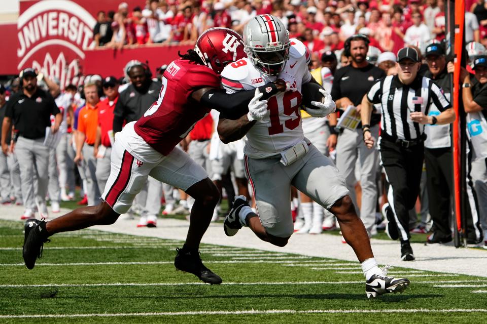 Sep 2, 2023; Bloomington, Indiana, USA; Ohio State Buckeyes running back Chip Trayanum (19) runs through Indiana Hoosiers defensive back Josh Sanguinetti (19) during the NCAA football game at Indiana University Memorial Stadium. Ohio State won 23-3.