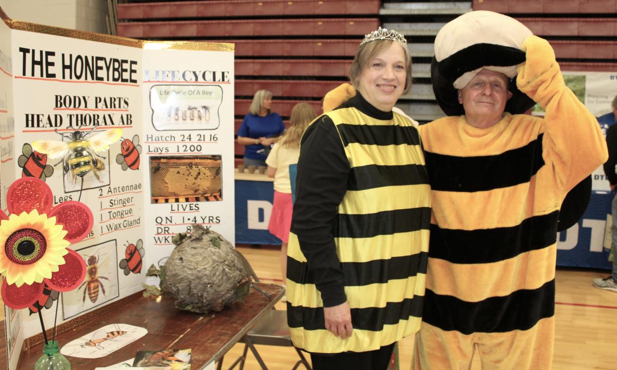 Dressed as bees, beekeepers Melanie Davis of Petersburg (left) and Bill Bray of Monroe shared information about what flowers to plant to attract bees at a previous Earth Day Expo. This year's expo is April 27.