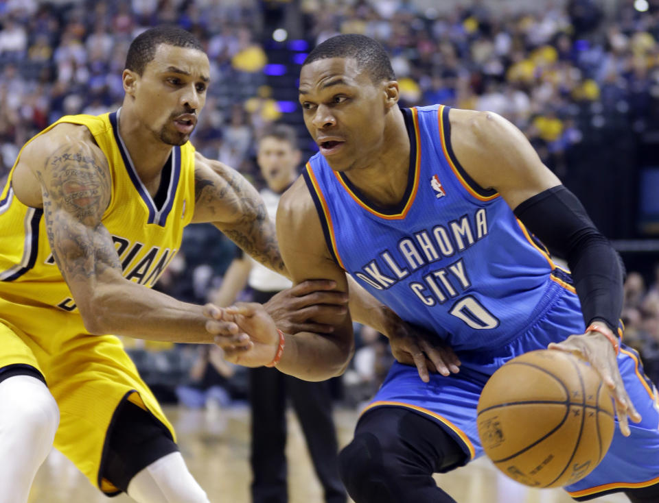Oklahoma City Thunder guard Russell Westbrook, right, drives against Indiana Pacers guard George Hill in the second half of an NBA basketball game in Indianapolis, Sunday, April 13, 2014. (AP Photo/Michael Conroy)