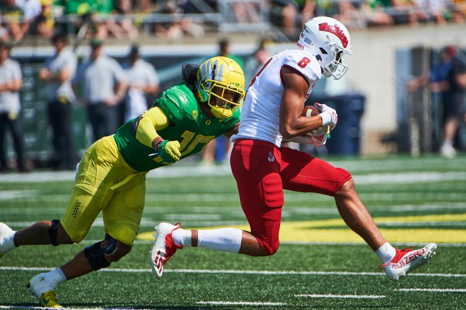 Fresno State Bulldogs wide receiver Ty Jones (8) picks up a first down during the second half as he gets tackled by Oregon Ducks linebacker Justin Flowe (10) at Autzen Stadium. The Ducks won the game 31-24.