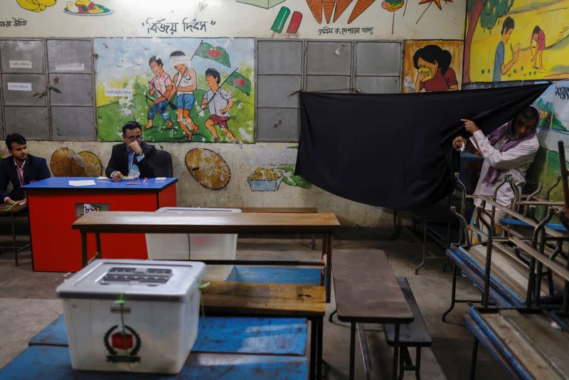 A voter comes out of a designated area after casting his vote during the 12th general election in Dhaka