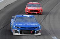 May 11, 2019; Kansas City, KS, USA; NASCAR Cup Series driver Kyle Larson (42) leads Daniel Suarez (41) during the Digital Ally 400 at Kansas Speedway. Mandatory Credit: Jasen Vinlove-USA TODAY Sports