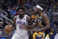 Philadelphia 76ers' Joel Embiid goes to the basket against Indiana Pacers' Myles Turner during the second half of an NBA basketball game, Monday, March 6, 2023, in Indianapolis. (AP Photo/Darron Cummings)