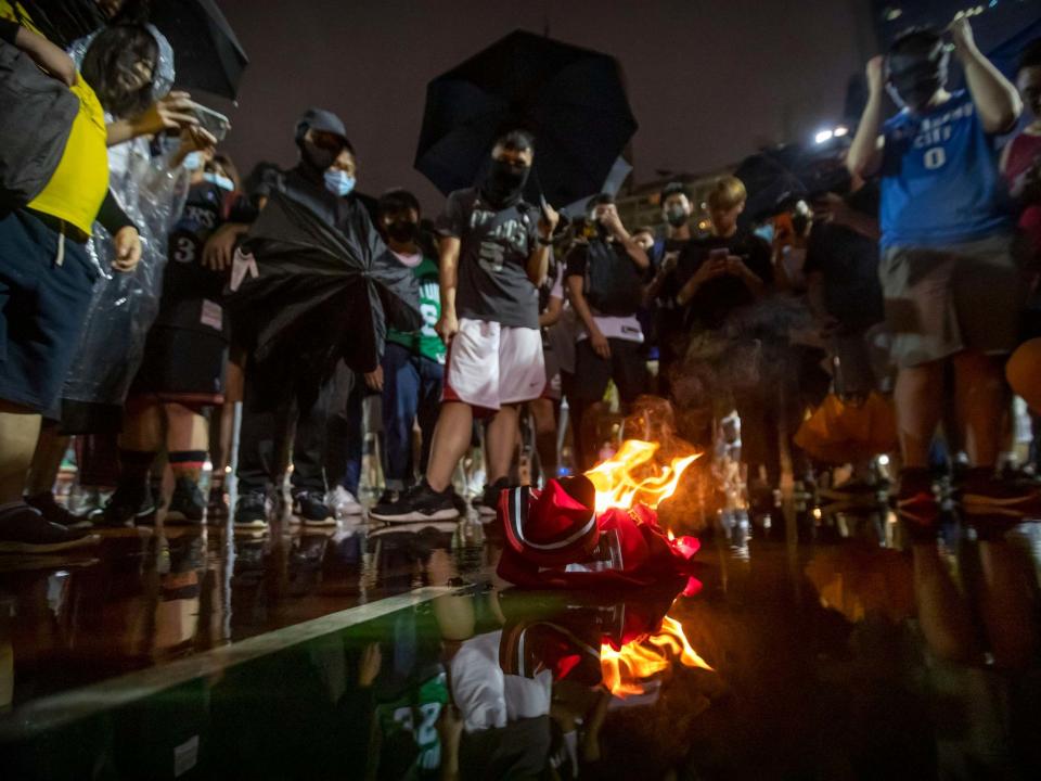 Demonstrators in Hong Kong burn a LeBron James basketball jersey in protest at his comments over free speech: AP