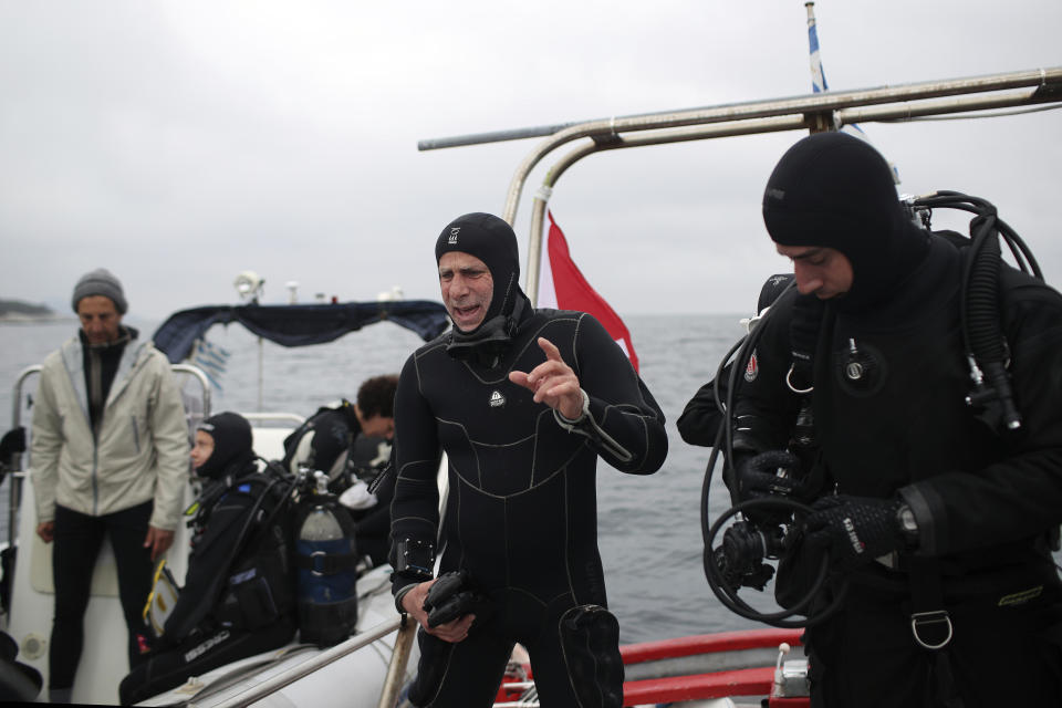 CAPTION CORRECTS THE PHOTOGRAPHER - In this photo taken on Sunday, April 7, 2019, lead archeologist for the project of opening wrecks to visitors Dimitris Kourkoumelis prepares to dive to a 5th Century B.C. shipwreck, the first ancient shipwreck to be opened to the public in Greece, including to recreational divers who will be able to visit the wreck itself, near the coast of Peristera, Greece. Greece’s rich underwater heritage has long been hidden from view, off-limits to all but a select few, mainly archaeologists. Scuba diving was banned throughout the country except in a few specific locations until 2005, for fear that divers might loot the countless antiquities that still lie scattered on the country’s seabed. Now that seems to be gradually changing, with a new project to create underwater museums. (AP Photo/Petros Giannakouris)