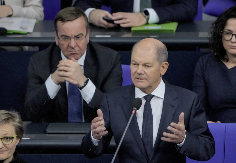 FILE -- German Defense Minister Boris Pistorius, rear left, looks on as German Chancellor Olaf Scholz, right, speaks to the lawmakers in the German parliament Bundestag in Berlin, Wednesday, Jan. 25, 2023. Nearly a year after Chancellor Olaf Scholz declared Russia’s invasion of Ukraine a 'turning point' that would trigger German weapons supplies to a country at war and a massive increase in spending on the German armed forces, his country’s military turnaround still has a long way to go. (Photo/Markus Schreiber, file)