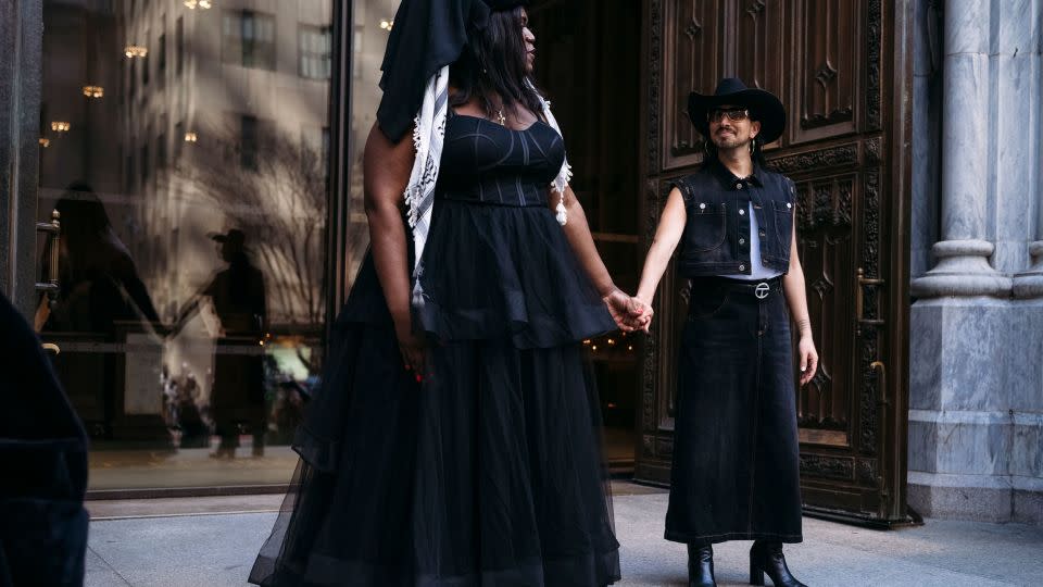 Qween Jean, founder of Black Trans Liberation, holds onto Oscar Diaz, right. - Laura Oliverio/CNN